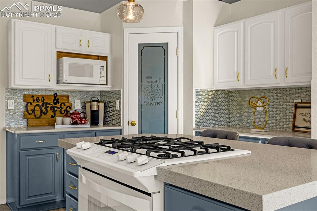 1310 Bison Ridge Drive Colorado Springs, CO 80919 - Photo 13 of 45 a kitchen with a stove and a sink