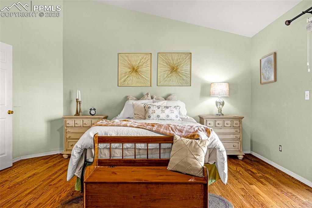 1310 Bison Ridge Drive Colorado Springs, CO 80919 - Photo 16 of 45 a bedroom with a bed and wooden floor