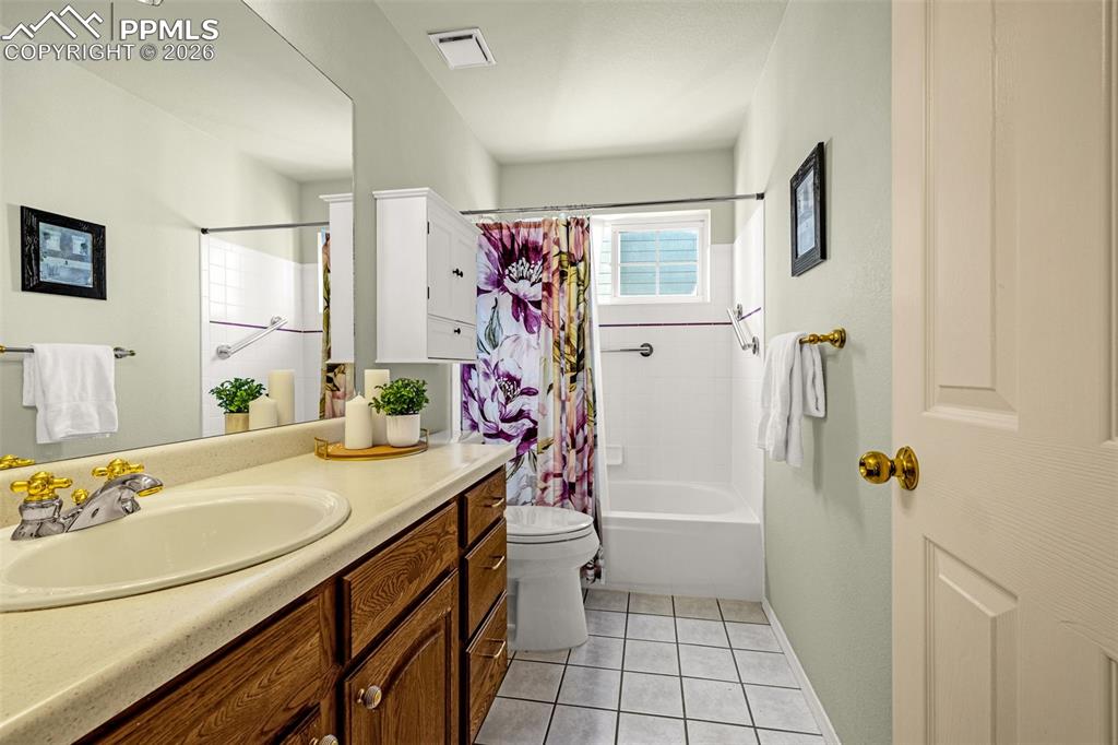 1310 Bison Ridge Drive Colorado Springs, CO 80919 - Photo 23 of 45 a bathroom with a sink a mirror a vanity and a shower