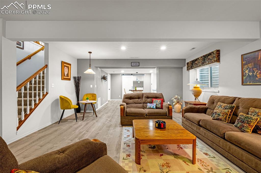 1310 Bison Ridge Drive Colorado Springs, CO 80919 - Photo 26 of 45 a living room with furniture and a couch