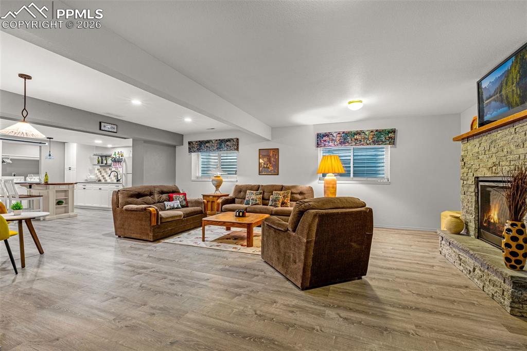 1310 Bison Ridge Drive Colorado Springs, CO 80919 - Photo 27 of 45 a living room with furniture and a fireplace