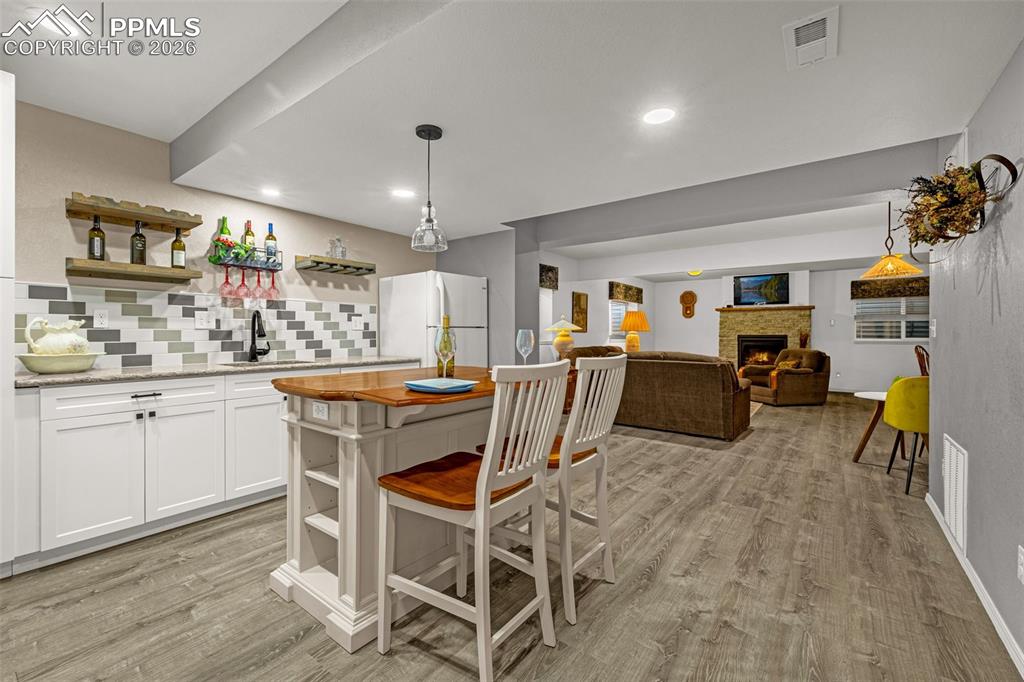 1310 Bison Ridge Drive Colorado Springs, CO 80919 - Photo 30 of 45 a view of a dining room with furniture and wooden floor