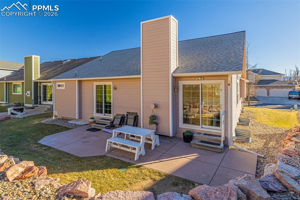 1310 Bison Ridge Drive Colorado Springs, CO 80919 - Photo 37 of 45 a view of a patio with a table and chairs