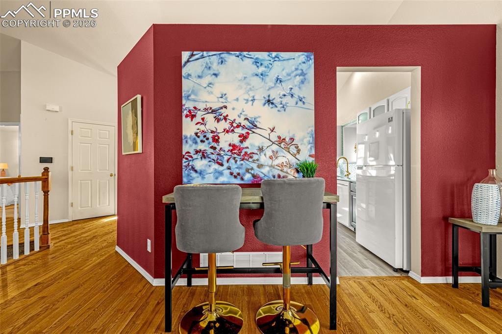 1310 Bison Ridge Drive Colorado Springs, CO 80919 - Photo 7 of 45 a view of a dining room with furniture and wooden floor