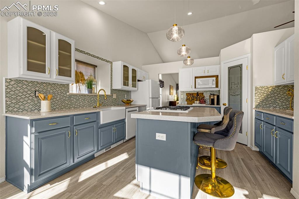 1310 Bison Ridge Drive Colorado Springs, CO 80919 - Photo 8 of 45 a kitchen with kitchen island granite countertop a sink counter top space and appliances