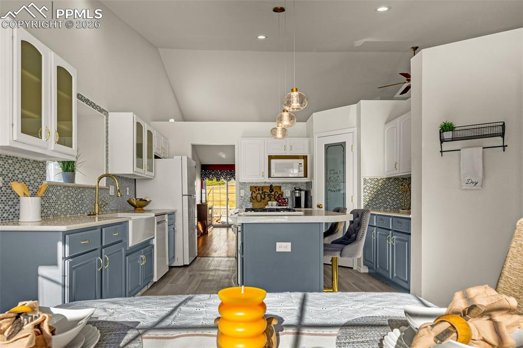 1310 Bison Ridge Drive Colorado Springs, CO 80919 - Photo 9 of 45 a kitchen with stainless steel appliances granite countertop a sink stove and refrigerator