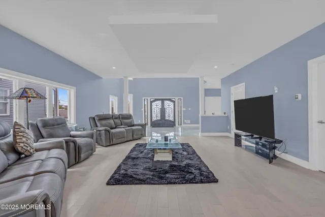 a kitchen with stainless steel appliances kitchen island granite countertop a table chairs and a refrigerator