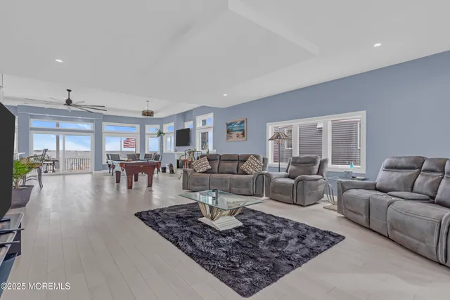 a kitchen with stainless steel appliances kitchen island granite countertop a table and chairs in it