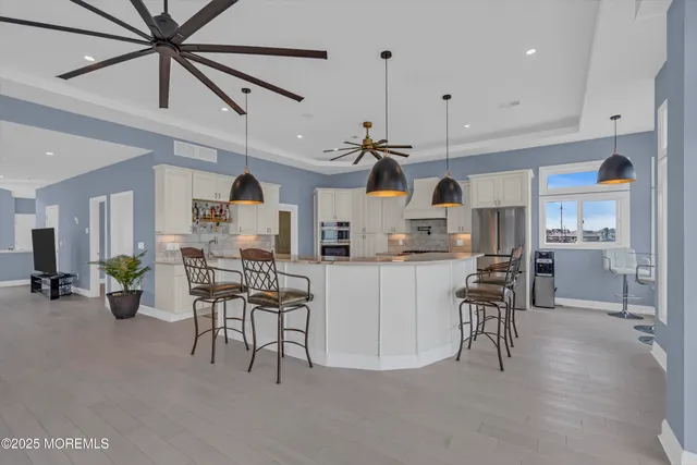 a bathroom with a toilet sink vanity and mirror