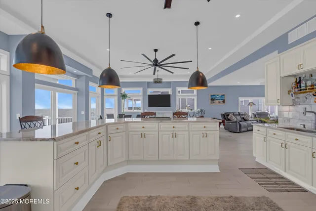 a spacious bathroom with a granite countertop sink and a mirror