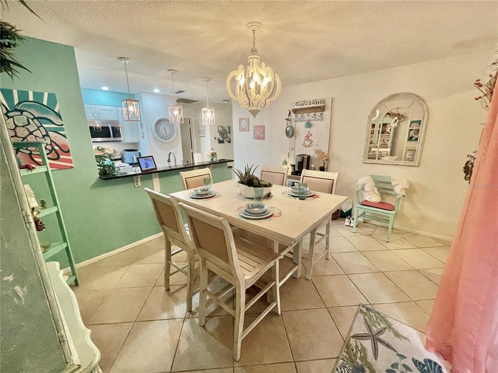 127 Cypress Pond Road Port Orange, FL 32128 - Photo 23 of 68 a dining room with granite countertop a table and chairs