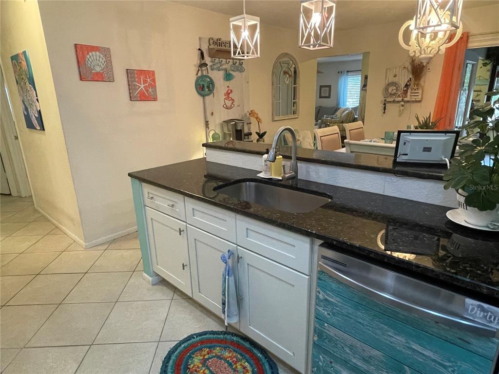 127 Cypress Pond Road Port Orange, FL 32128 - Photo 31 of 68 a kitchen with granite countertop a sink a stove and cabinets