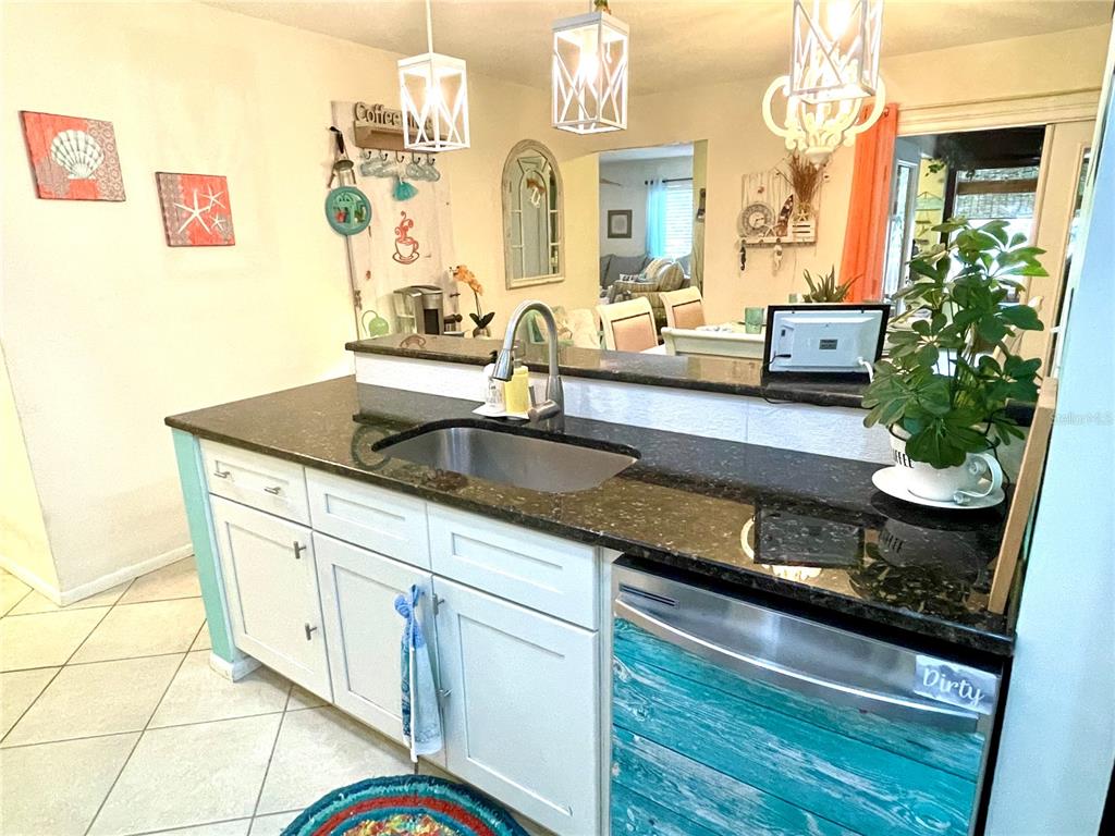 127 Cypress Pond Road Port Orange, FL 32128 - Photo 33 of 68 a kitchen with granite countertop a sink a stove and cabinets