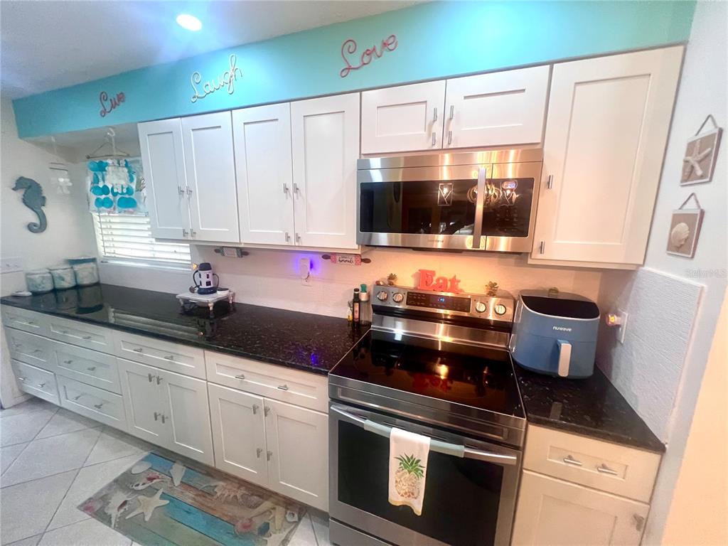 127 Cypress Pond Road Port Orange, FL 32128 - Photo 36 of 68 a kitchen with a stove a sink and a microwave