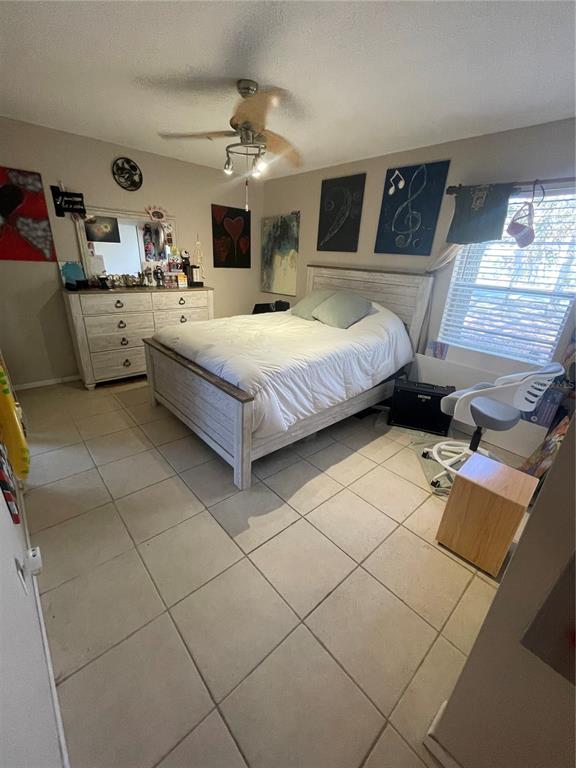 127 Cypress Pond Road Port Orange, FL 32128 - Photo 42 of 68 a bedroom with a bed and lamp on the dresser