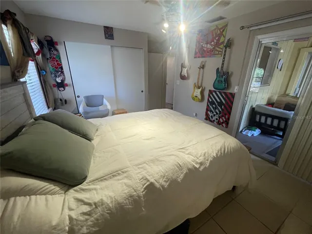 a bedroom with a bed and a painting on the wall