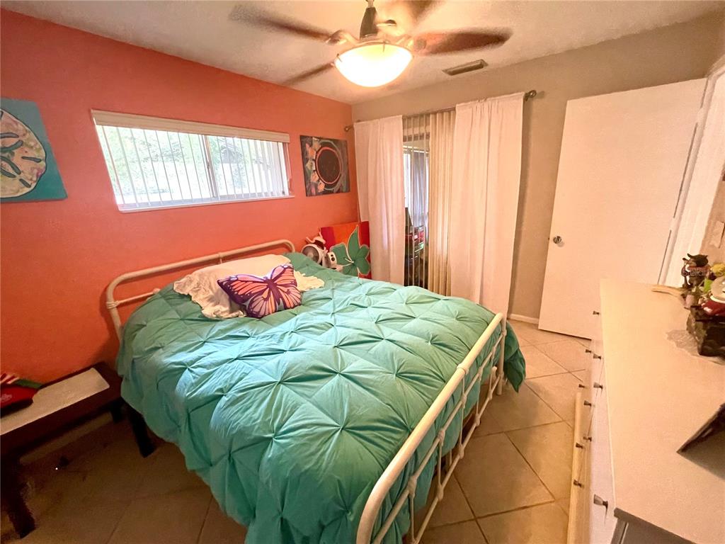 127 Cypress Pond Road Port Orange, FL 32128 - Photo 54 of 68 a bedroom with a bed and a chandelier