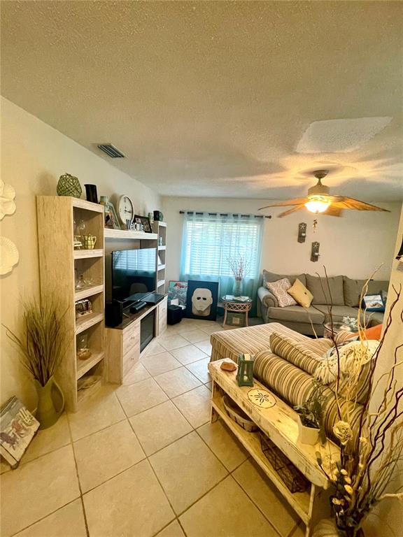 127 Cypress Pond Road Port Orange, FL 32128 - Photo 59 of 68 a bedroom with furniture and a flat screen tv