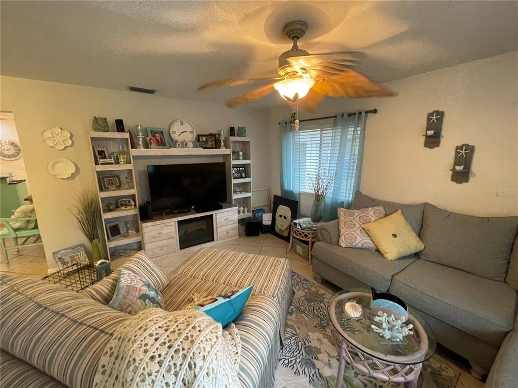 127 Cypress Pond Road Port Orange, FL 32128 - Photo 62 of 68 a living room with furniture and a flat screen tv