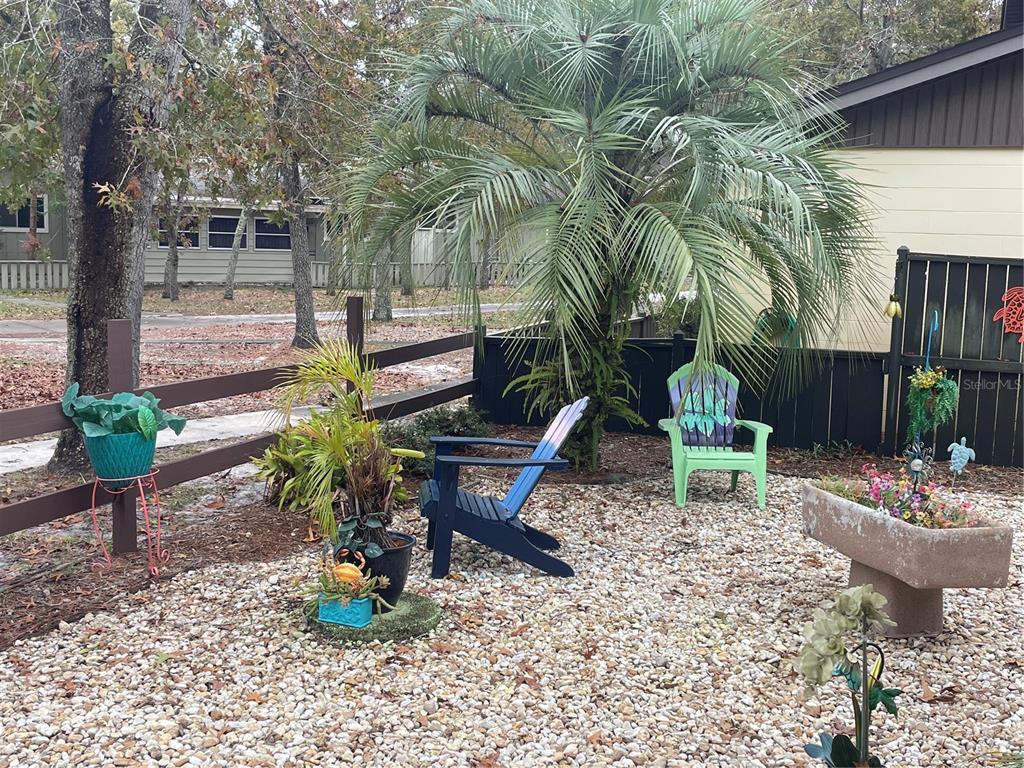 127 Cypress Pond Road Port Orange, FL 32128 - Photo 8 of 68 a view of a backyard with plants and chairs