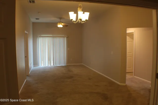 a view of a chandelier and a chandelier in a room