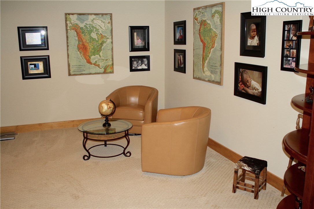 138 South Camp Road, Unit 104 Boone, NC 28607 - Photo 29 of 33 a living room with furniture and paintings on the wall