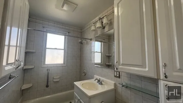 a bathroom with a sink mirror toilet and bathtub
