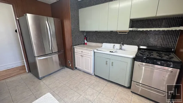 a kitchen with a sink stove and refrigerator