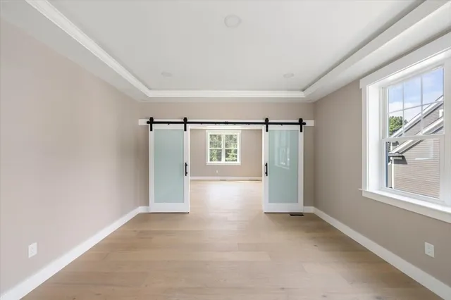 an empty room with windows and closet