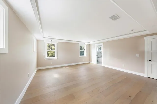 an empty room with windows and closet