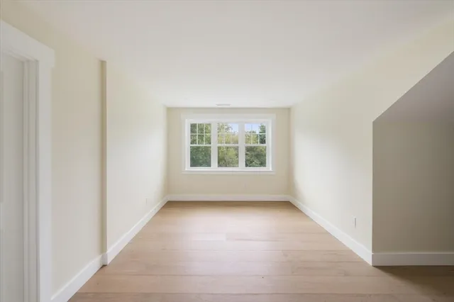 an empty room with large windows