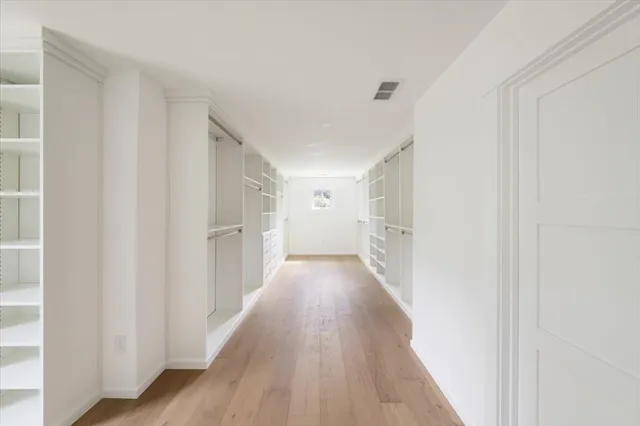 a view of a hallway with wooden floor