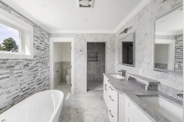 a bathroom with a granite countertop sink mirror and bathtub