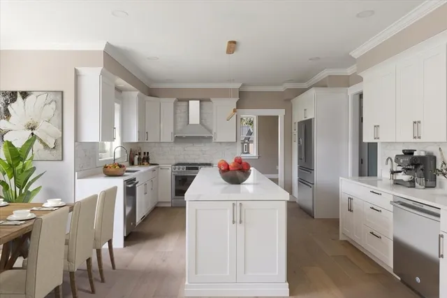 a kitchen with white cabinets and sink