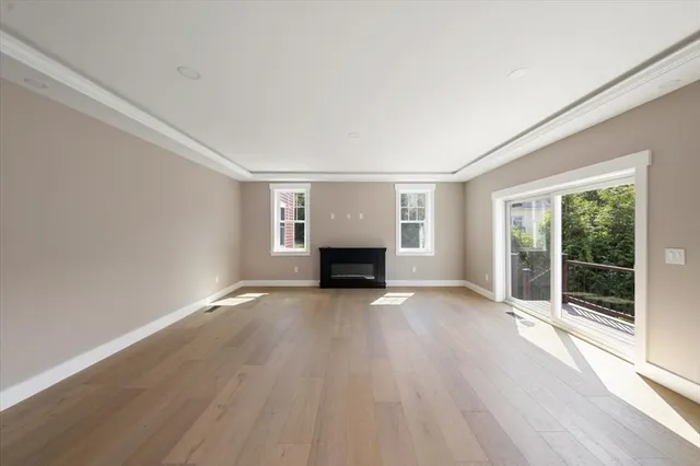 an empty room with windows fireplace and windows