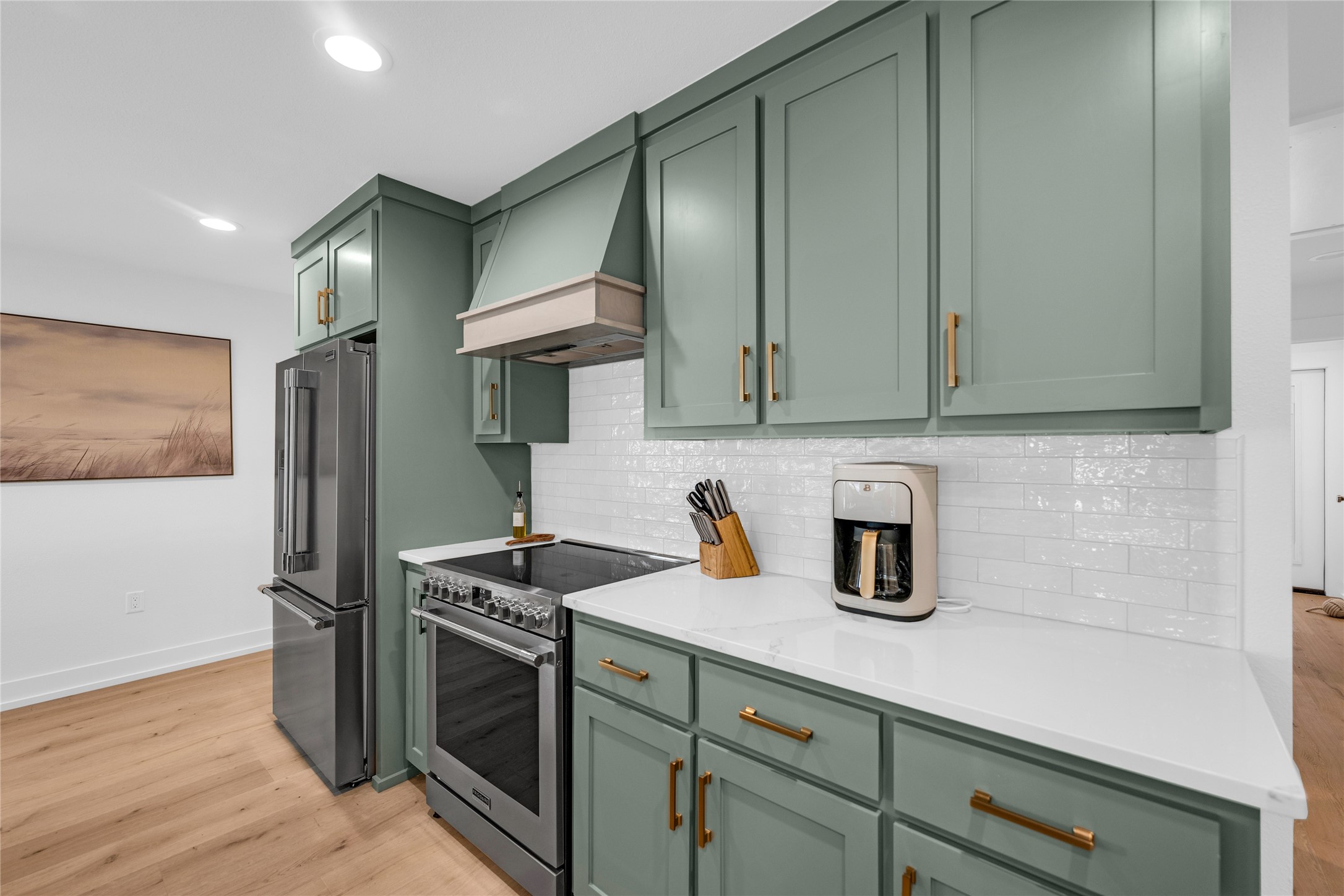 2477 Gilmore Crystal Beach, TX 77650 - Photo 16 of 40 a kitchen with stainless steel appliances granite countertop a refrigerator and a stove