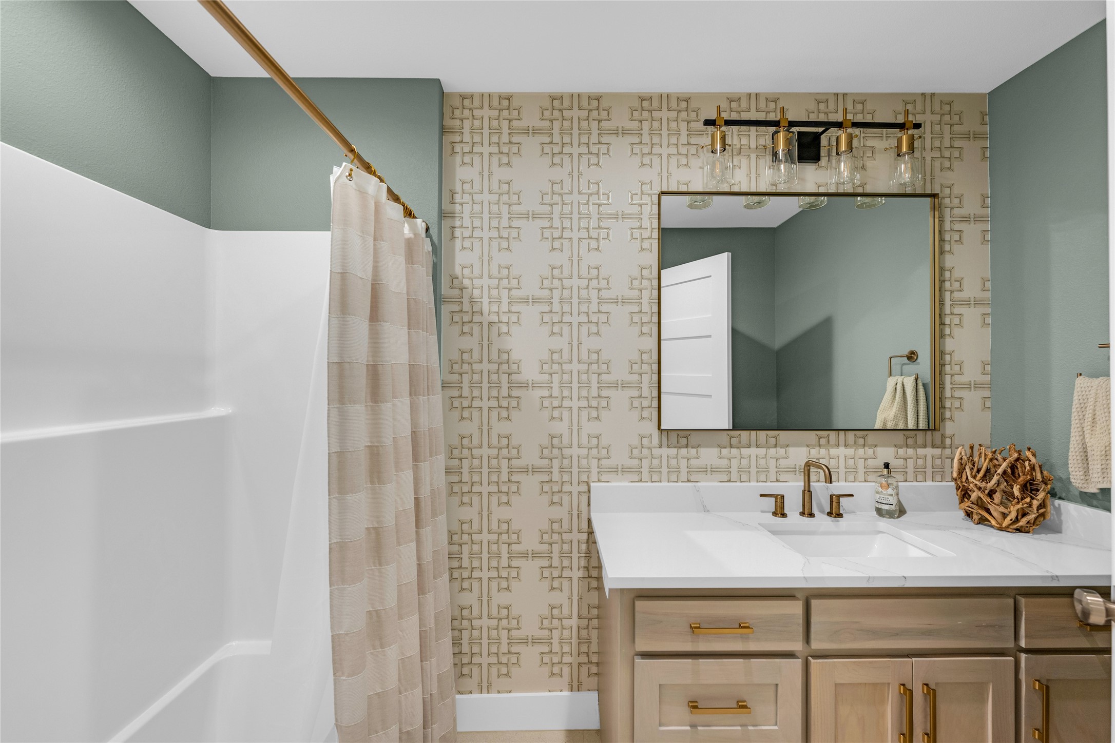 2477 Gilmore Crystal Beach, TX 77650 - Photo 24 of 40 a bathroom with a granite countertop sink and a mirror