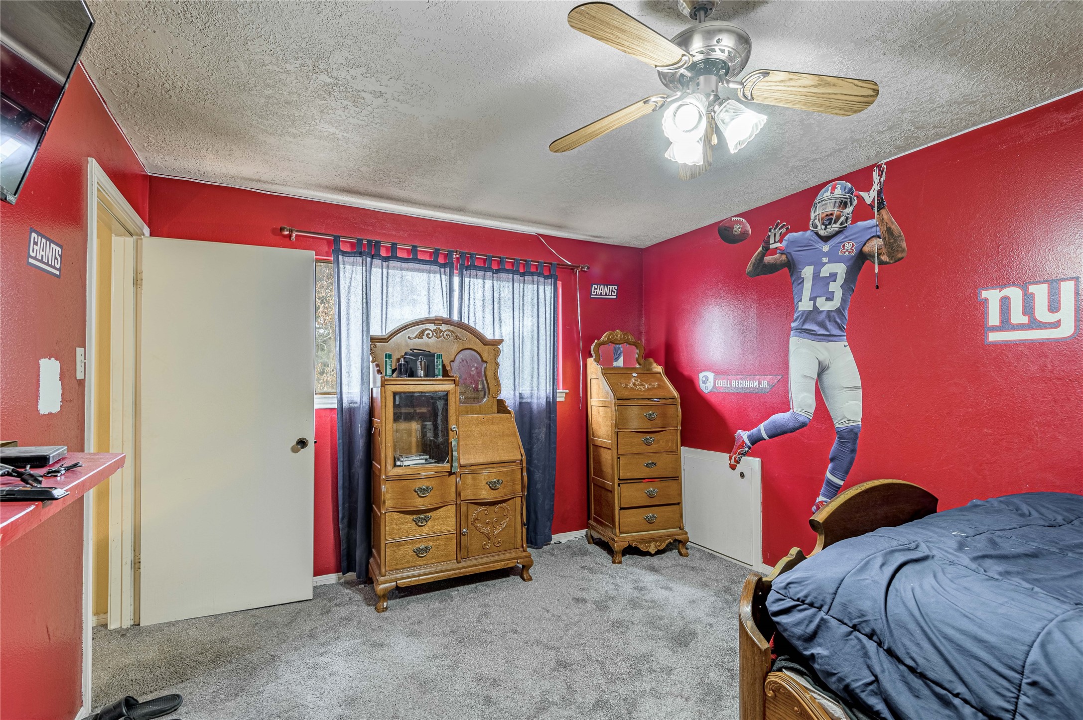 7640 Highway 75 Huntsville, TX 77340 - Photo 41 of 49 a bedroom with bed and a chandelier