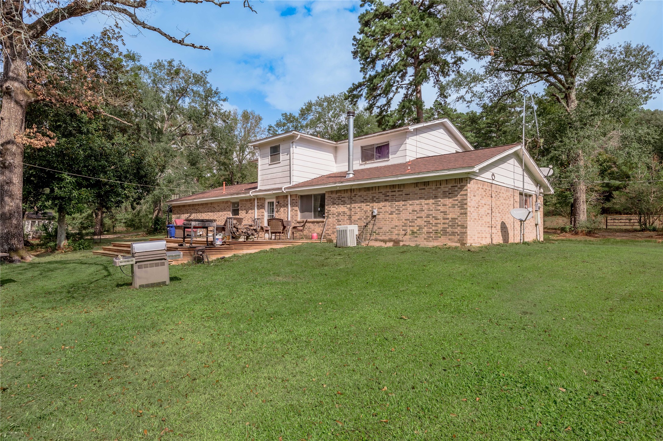 7640 Highway 75 Huntsville, TX 77340 - Photo 6 of 49 a view of a house with a big yard and large trees