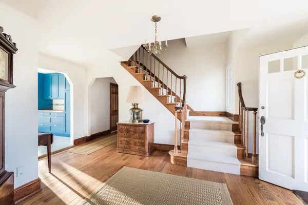 a view of entryway and hall with wooden floor