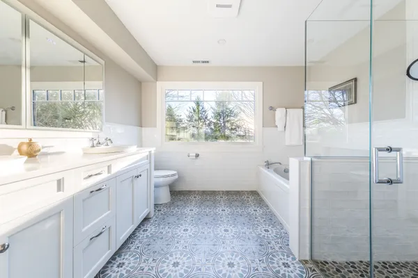 a bathroom with a sink a toilet and shower