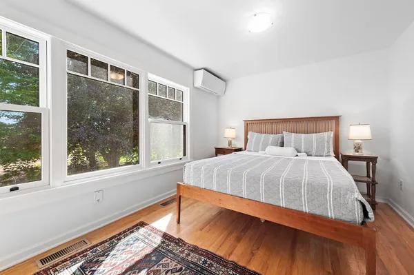 a bedroom with a bed and a large window
