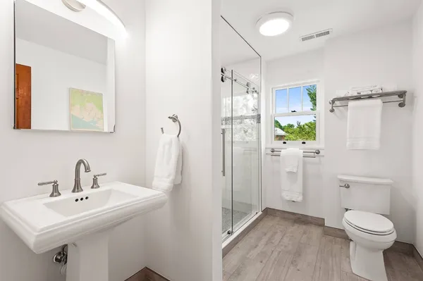 a bathroom with a sink toilet and shower