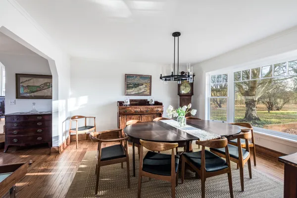 a view of a dining room with furniture window and wooden floor