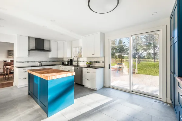 a kitchen with stainless steel appliances granite countertop a stove a sink and a refrigerator