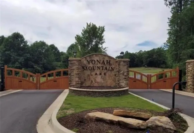 a view of a garden with houses in the background