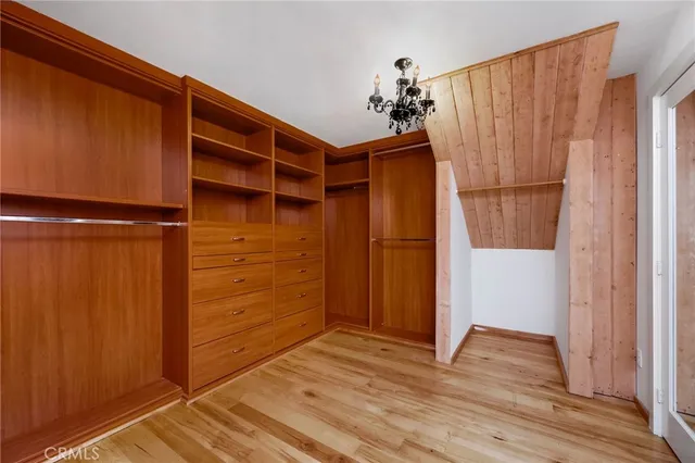 a view of an empty room with wooden floor and entryway
