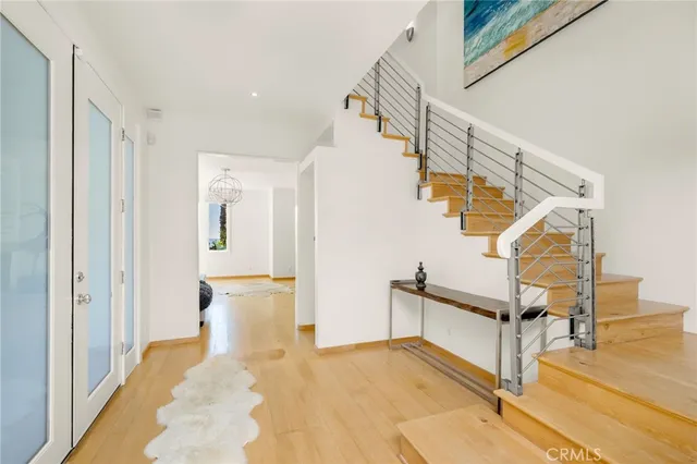 a view of entryway and hall with wooden floor