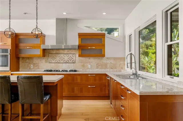 a kitchen with a sink a counter top space and appliances