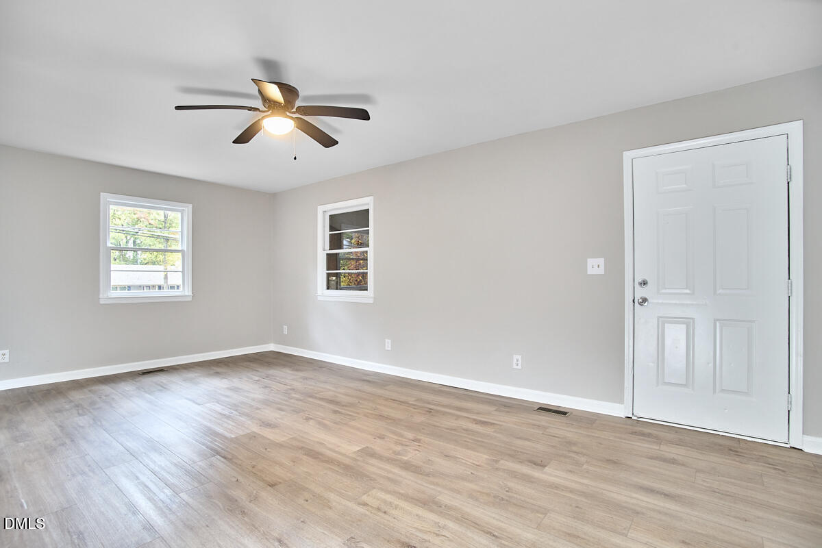 2128 Strebor Street Durham, NC 27705 - Photo 11 of 51 a view of empty room with wooden floor and fan
